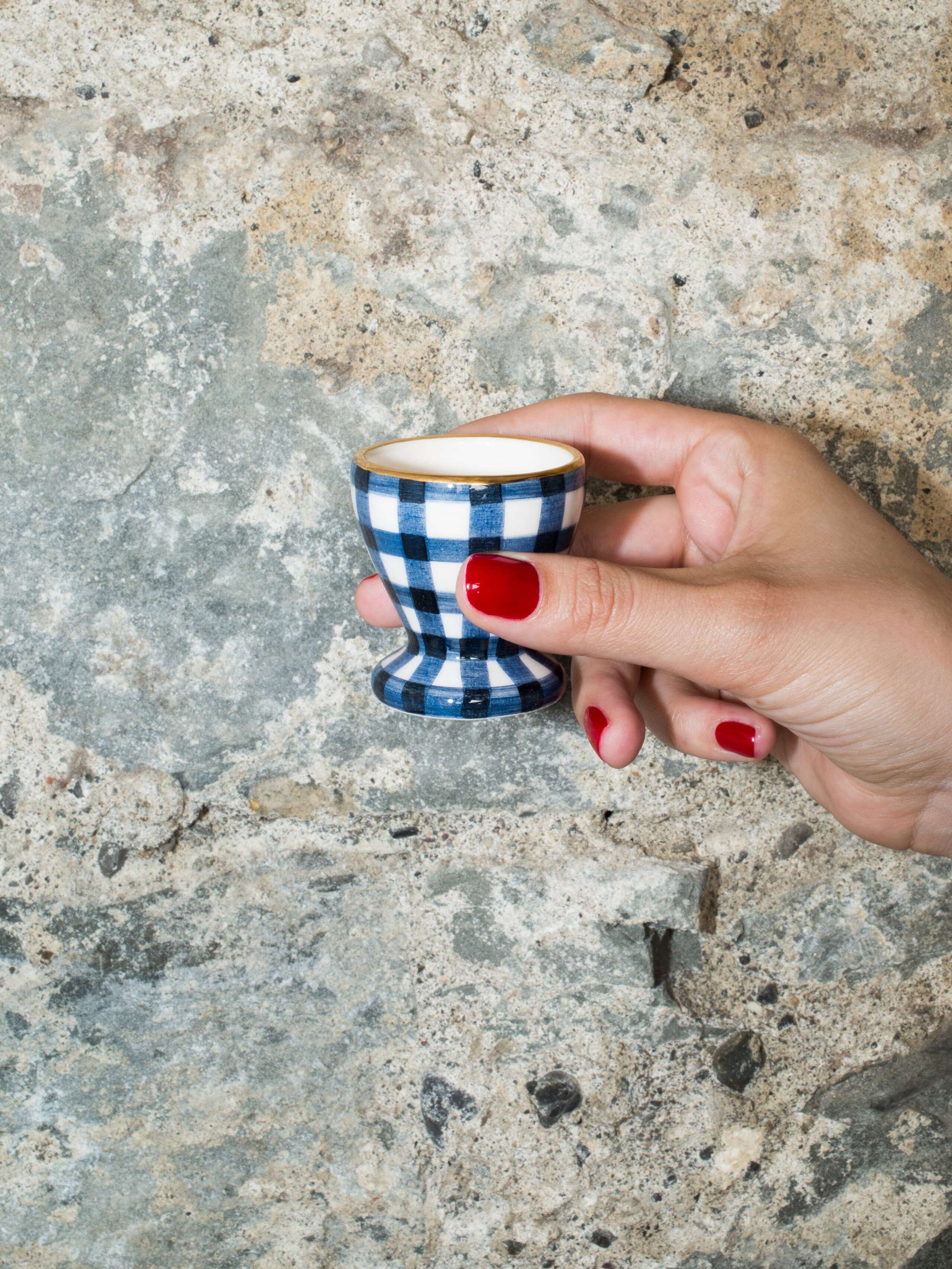person holding egg cup 