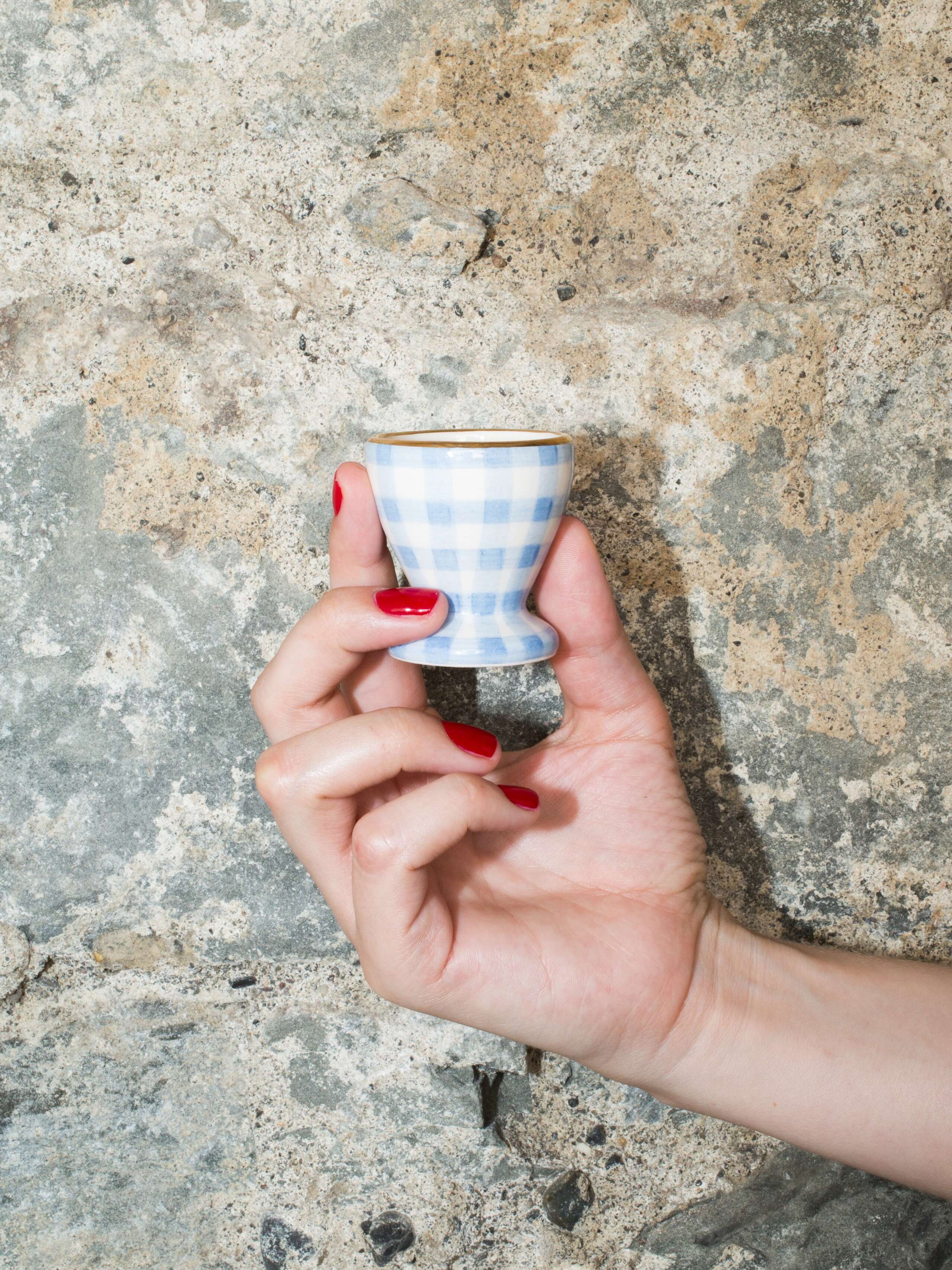 person holding egg cup 