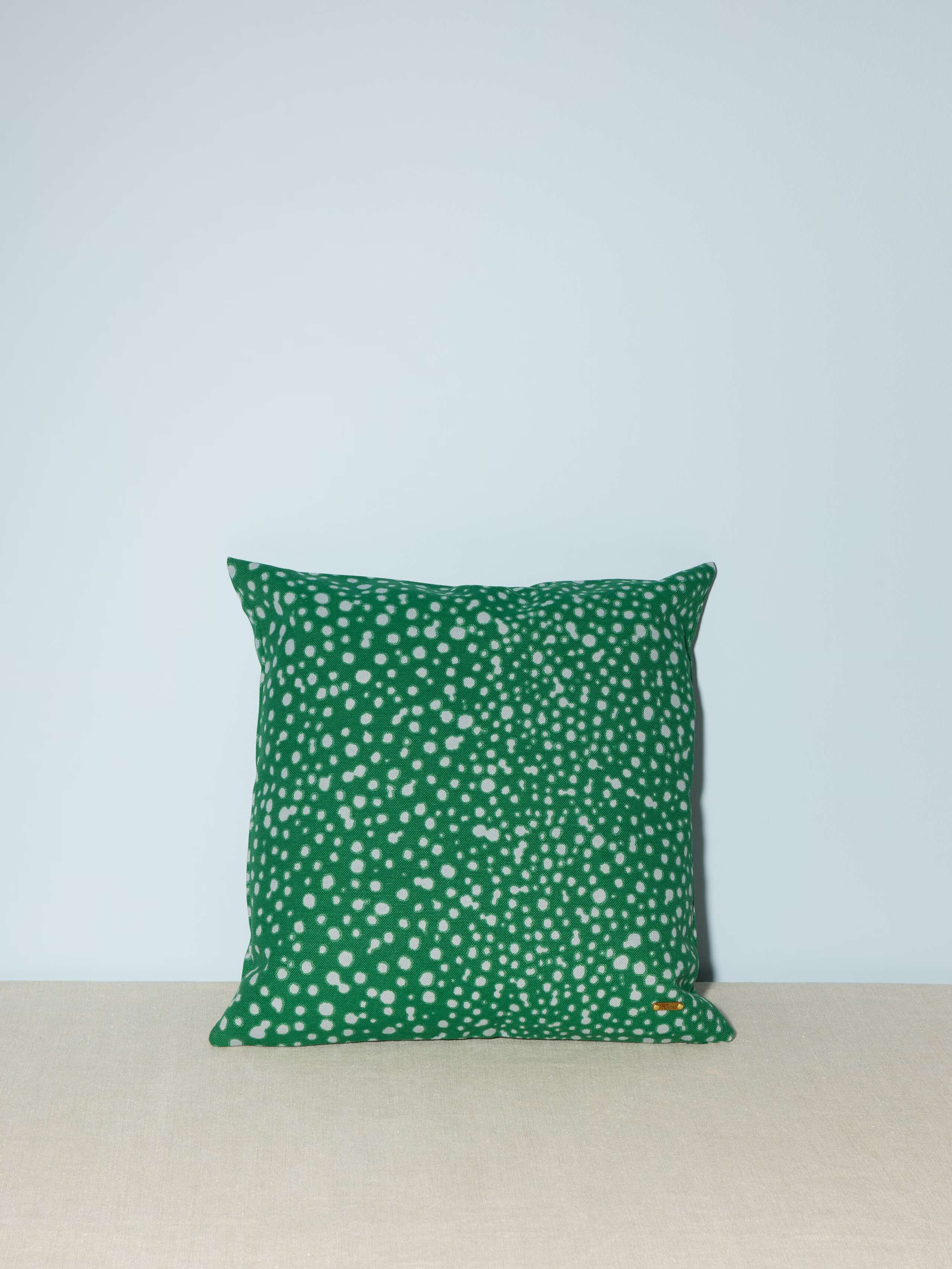 small pillow cover in green with light blue Leo dots