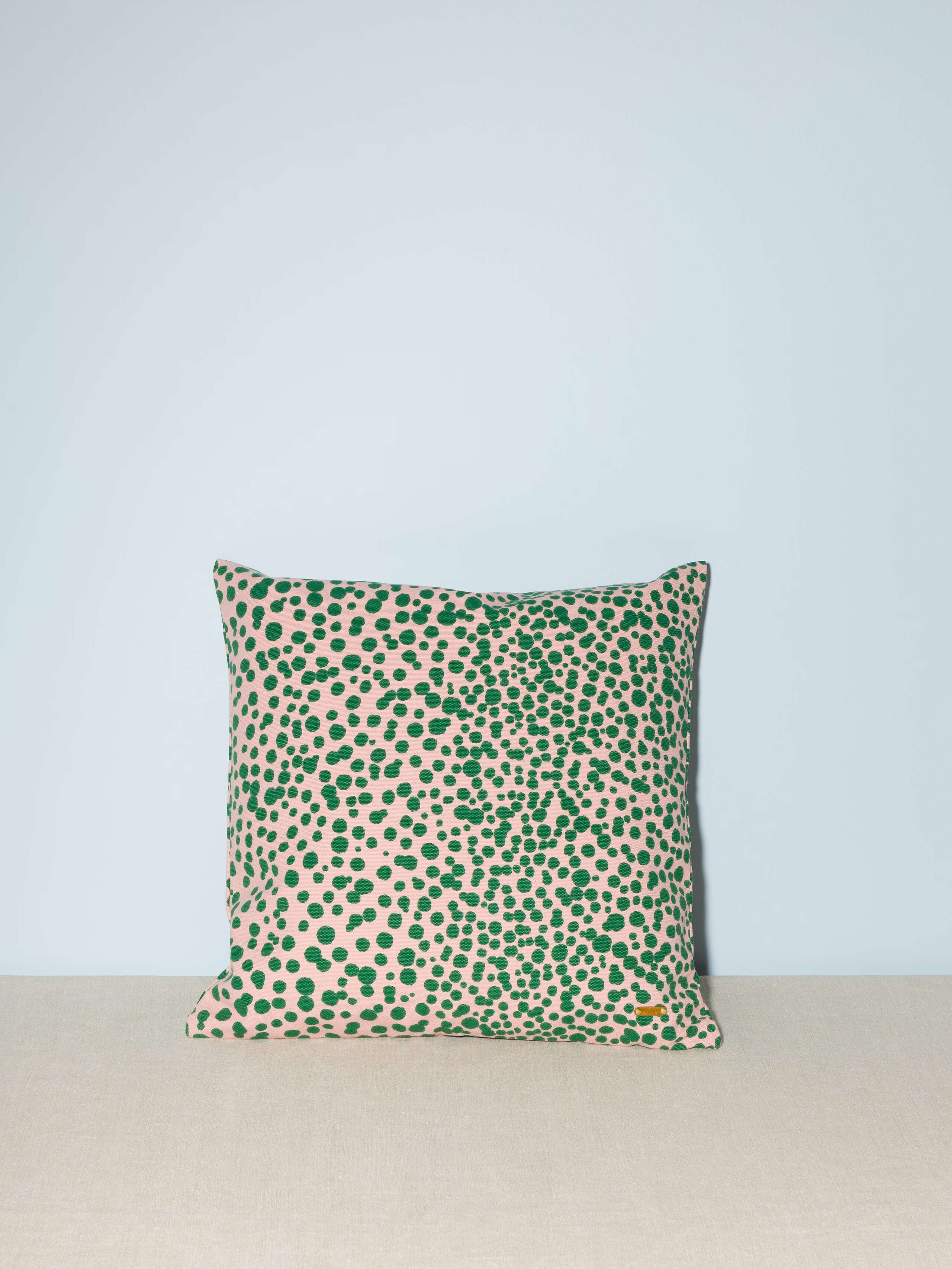 small pillow cover in pink with green leo dots