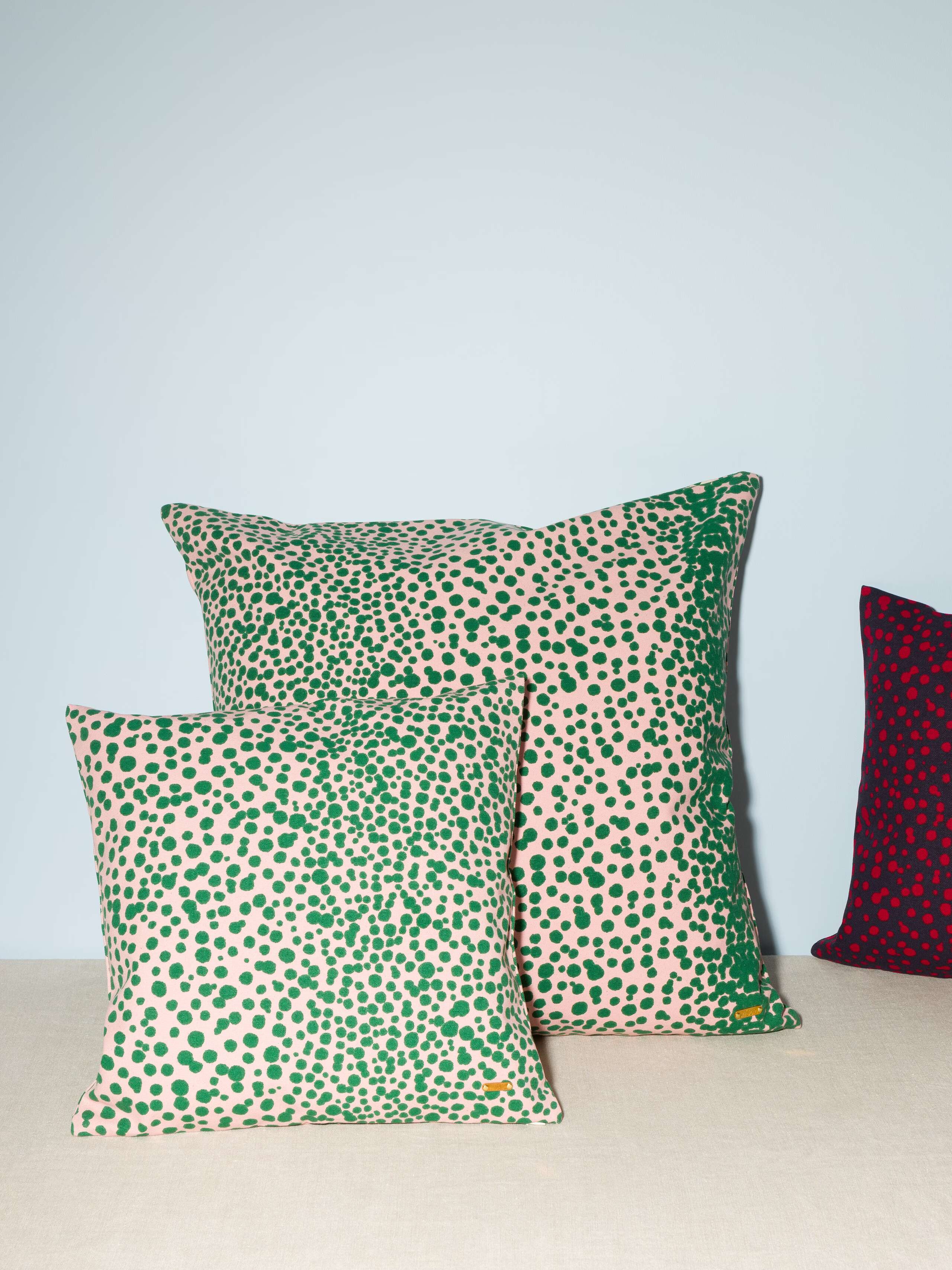 two pillow covers in pink with green leo dots