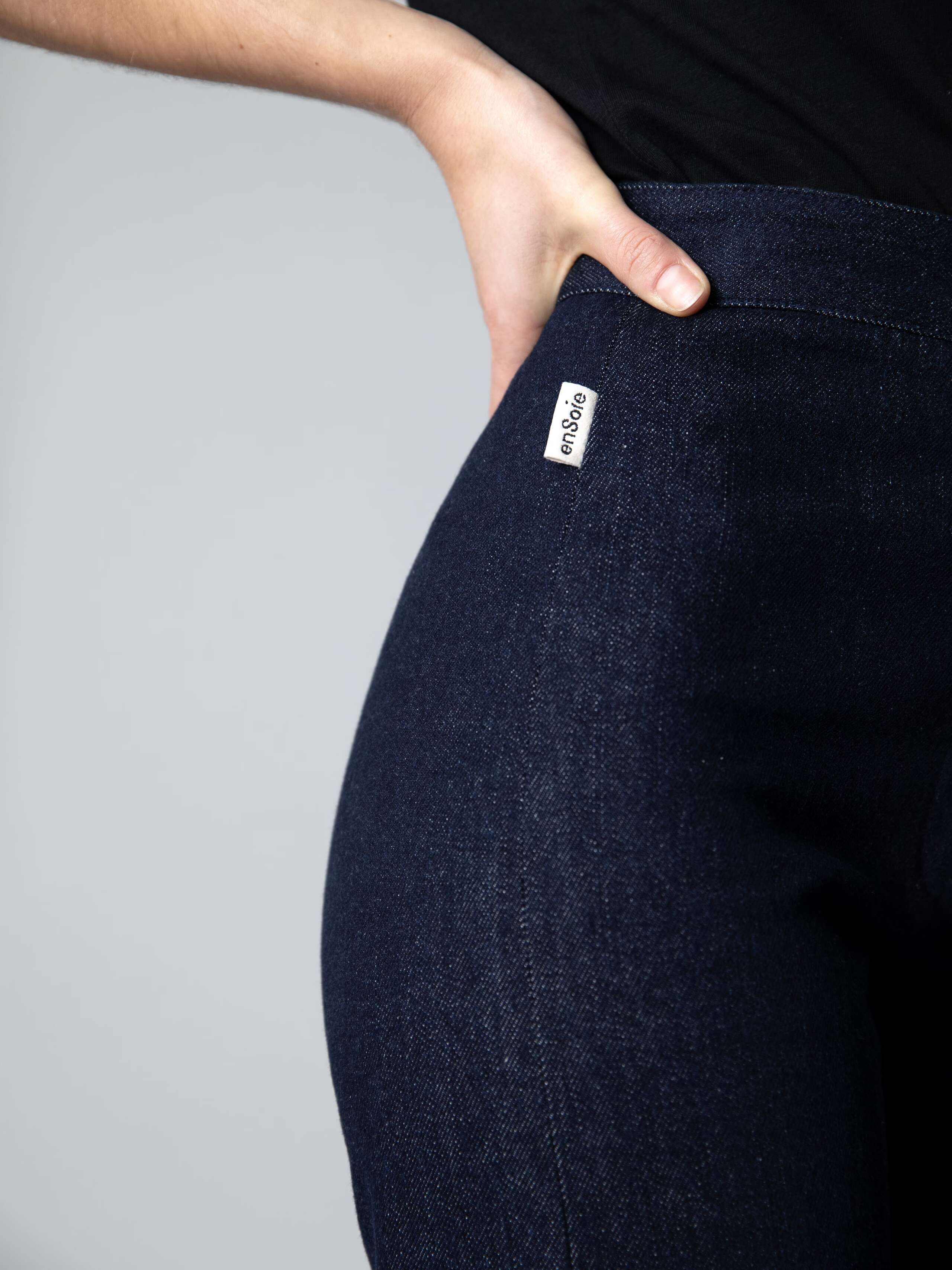 Detail of a beautiful wide leg and high waist denim trousers and a black cotton shirt