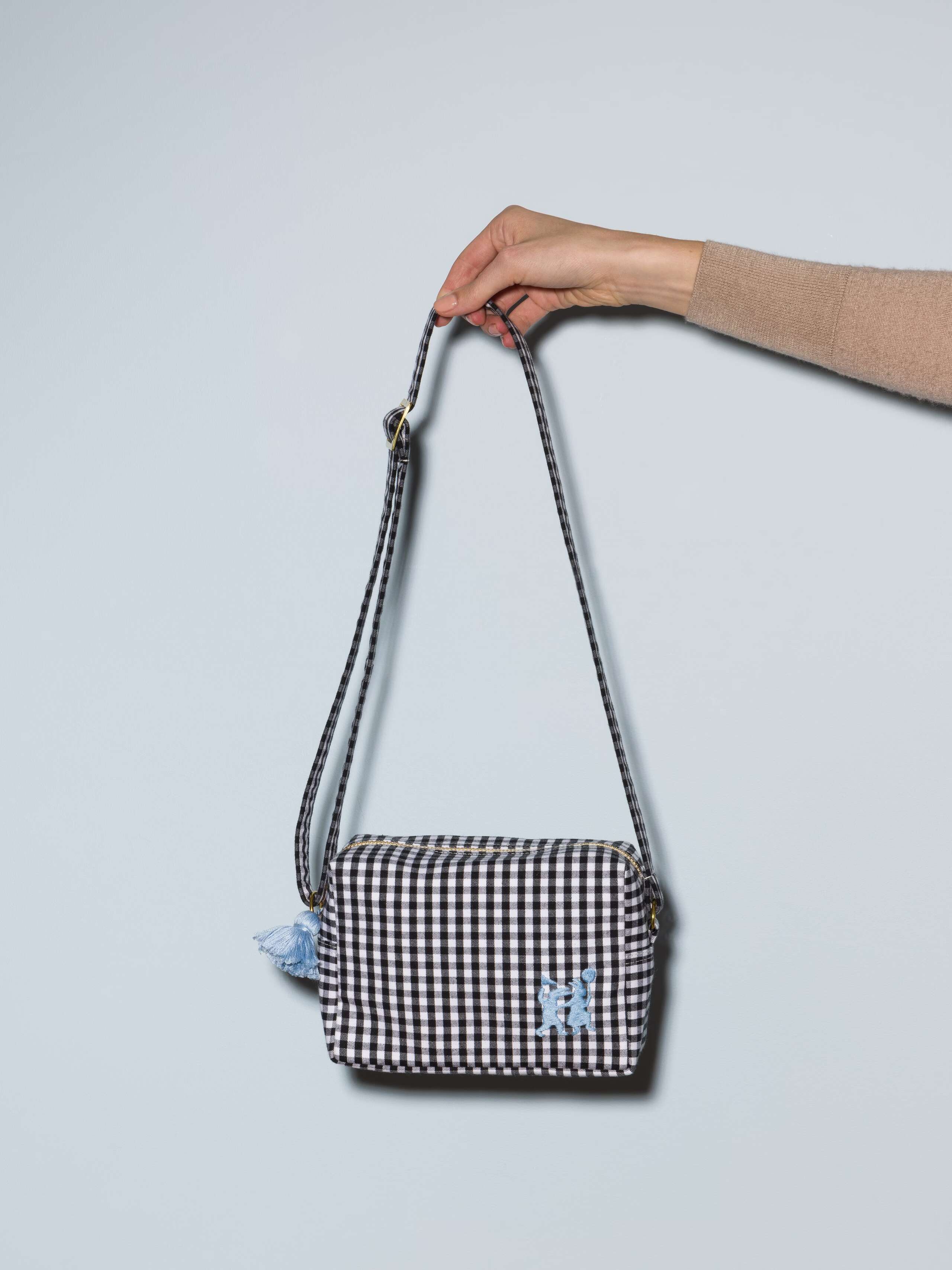 Picture of a kindergarten bag featuring a beautiful black and white vichy check pattern and a cute lightblue rabbit embroidery 