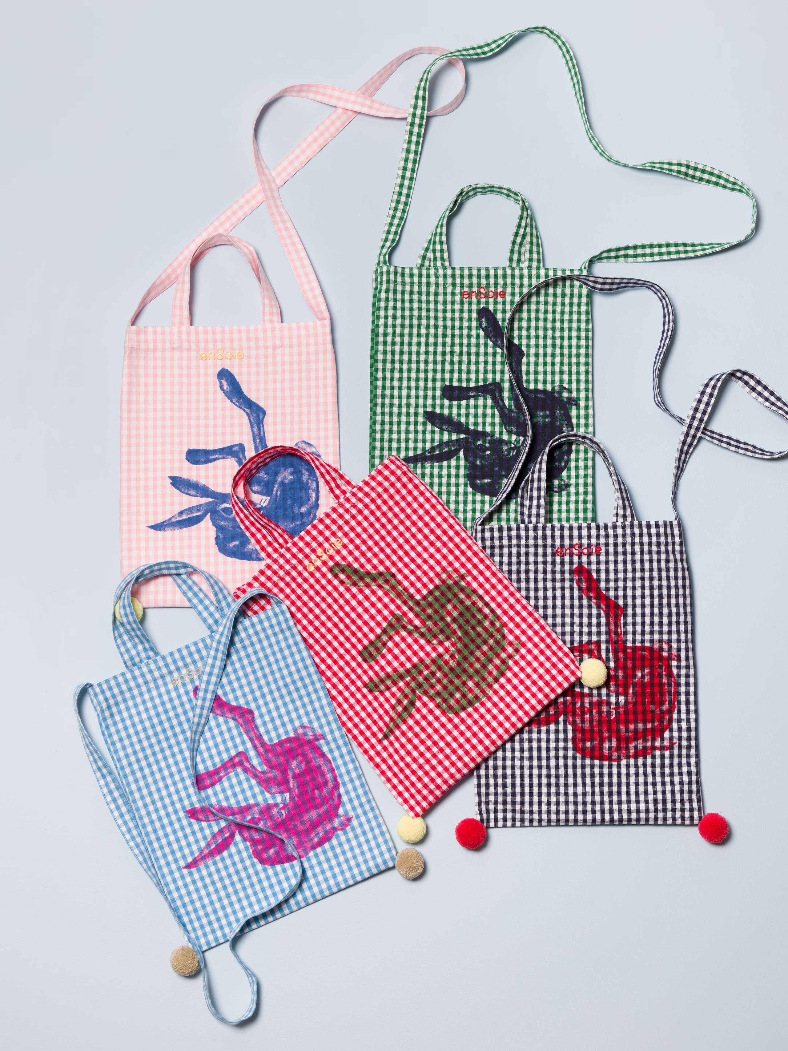 Five beautiful small tote bags featuring colourful pompoms and a cute rabbit print