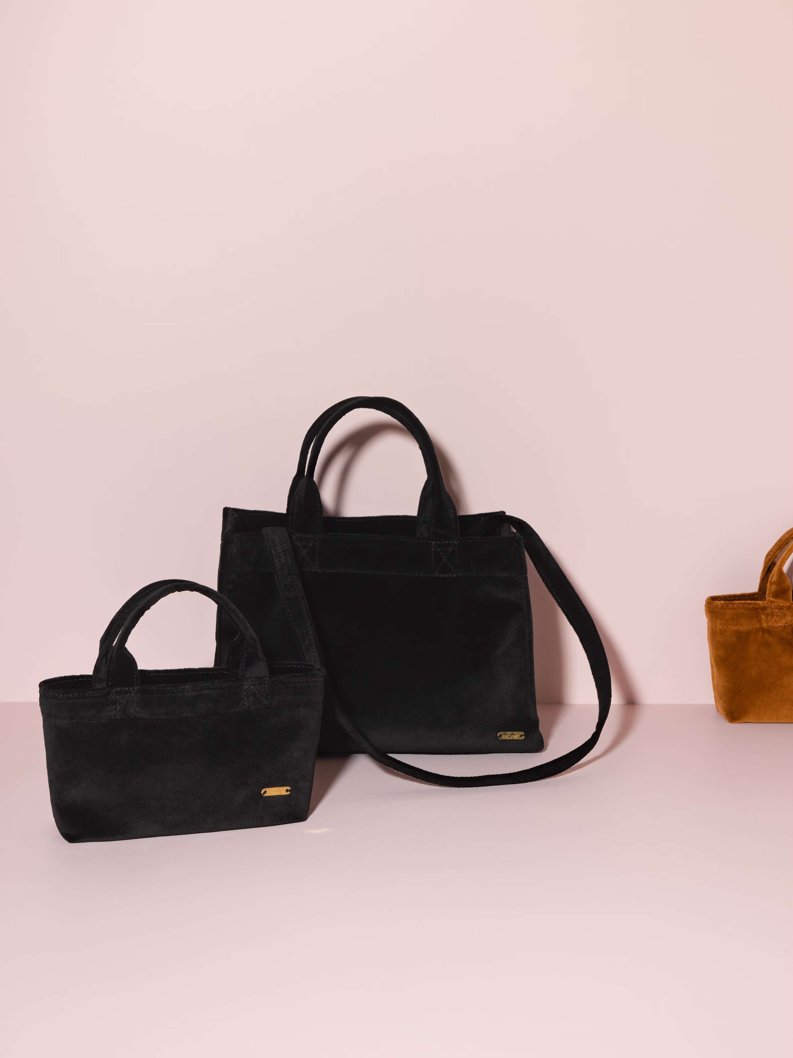 Picture of two handbags made of black coloured velvet