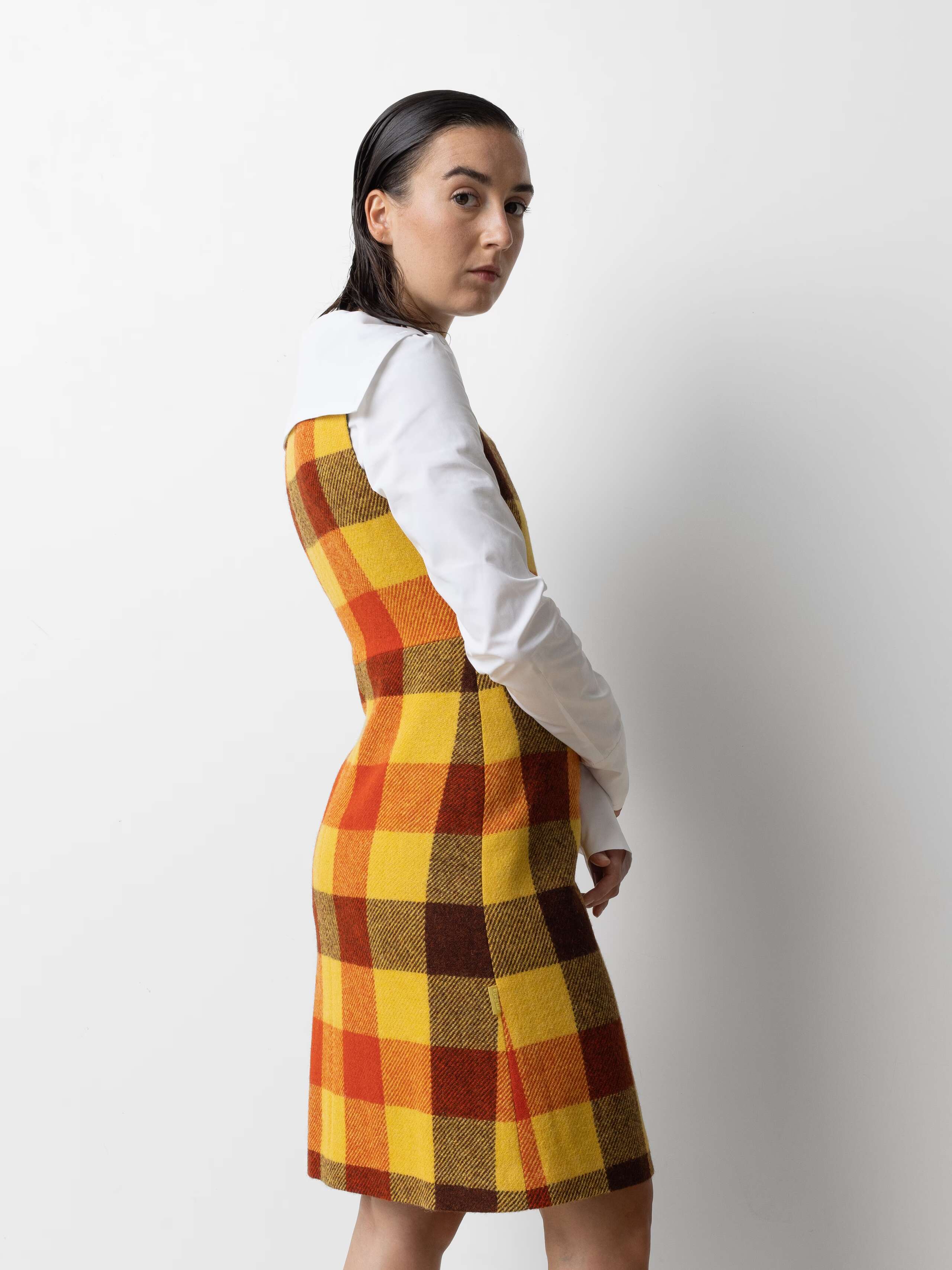 Picture of a female model wearing a colourful wool dress