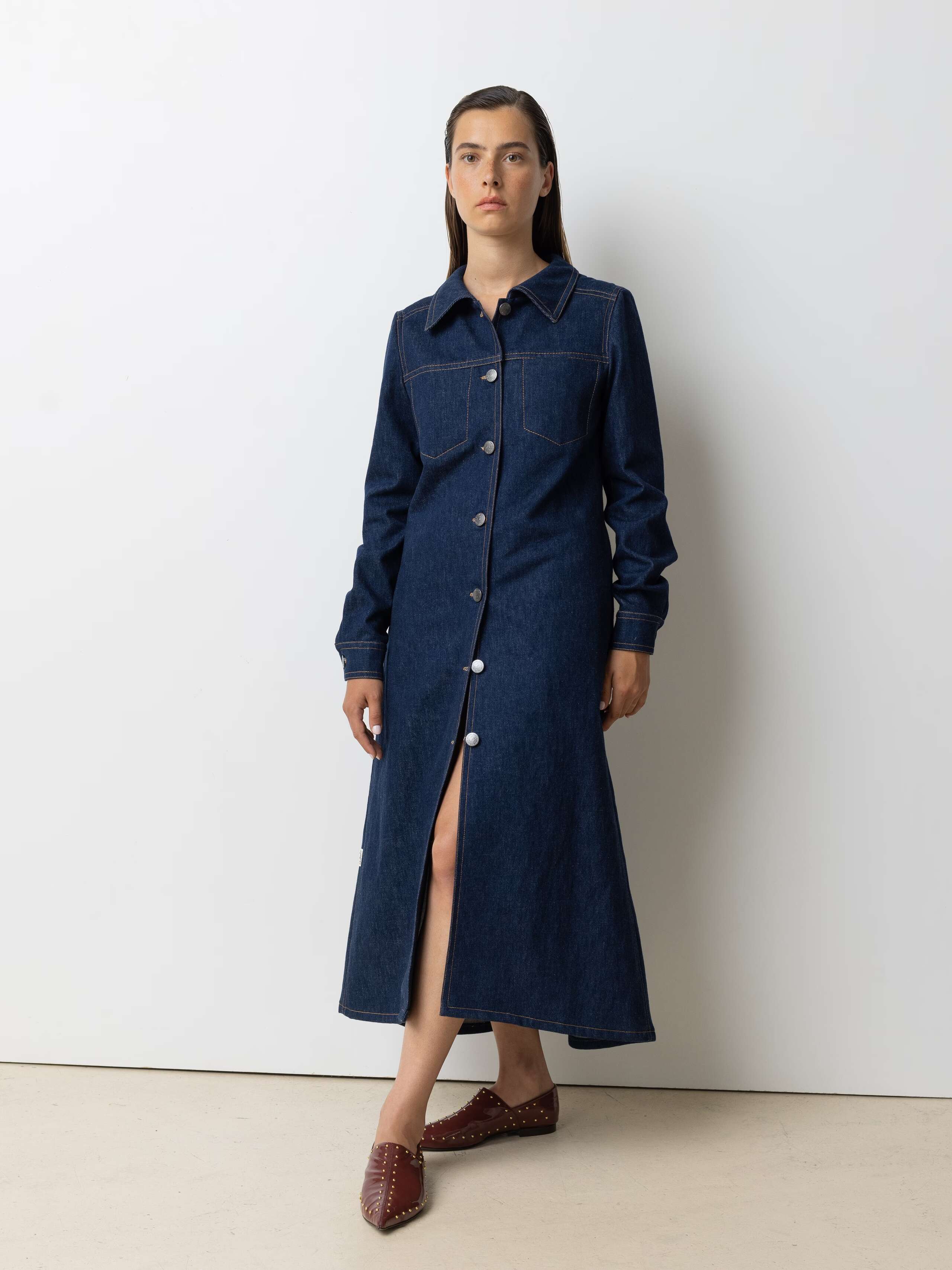 Picture of a female model wearing a long denim dress