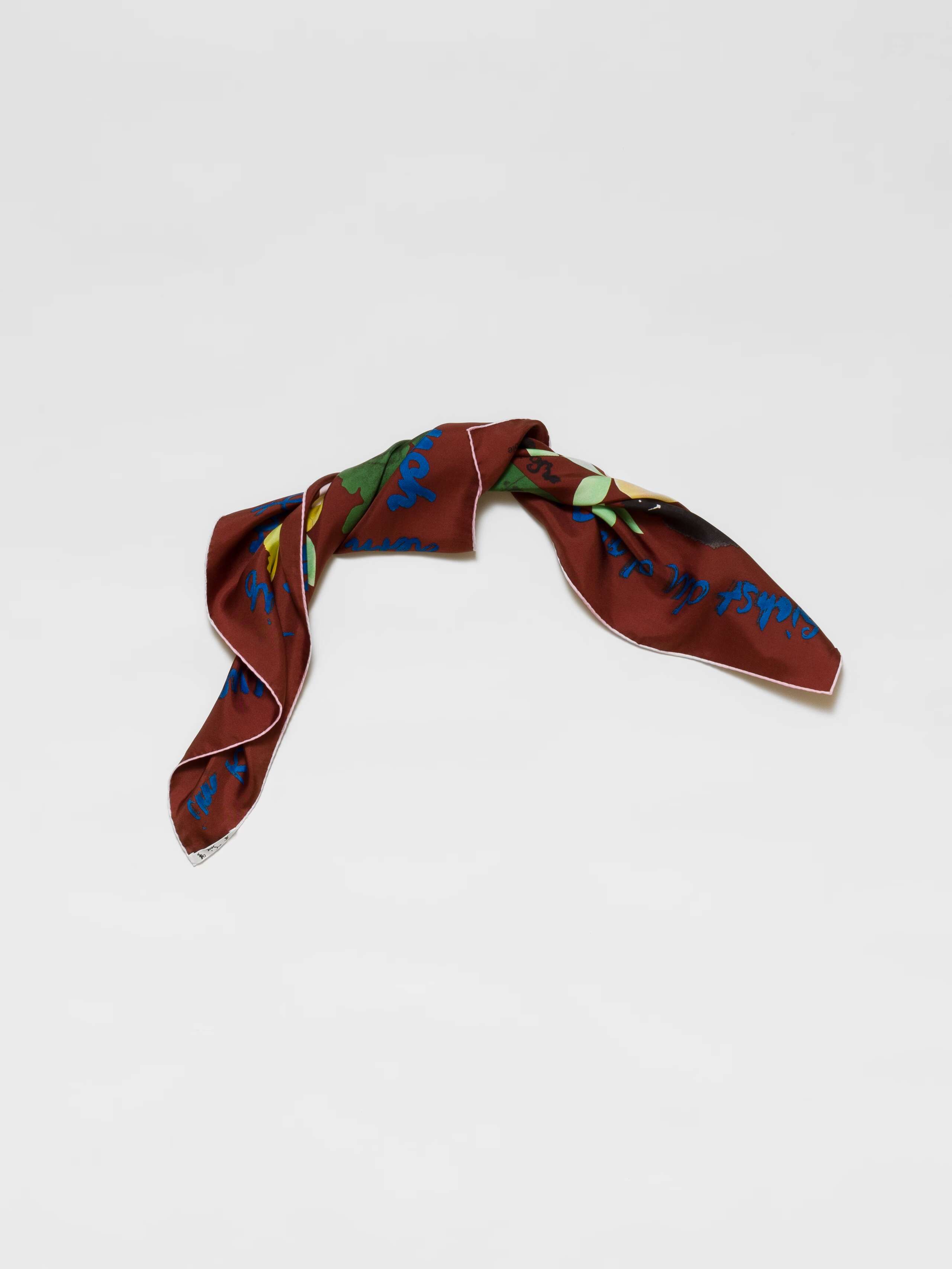 Picture of a brown silk foulard featuring a colourful apple print