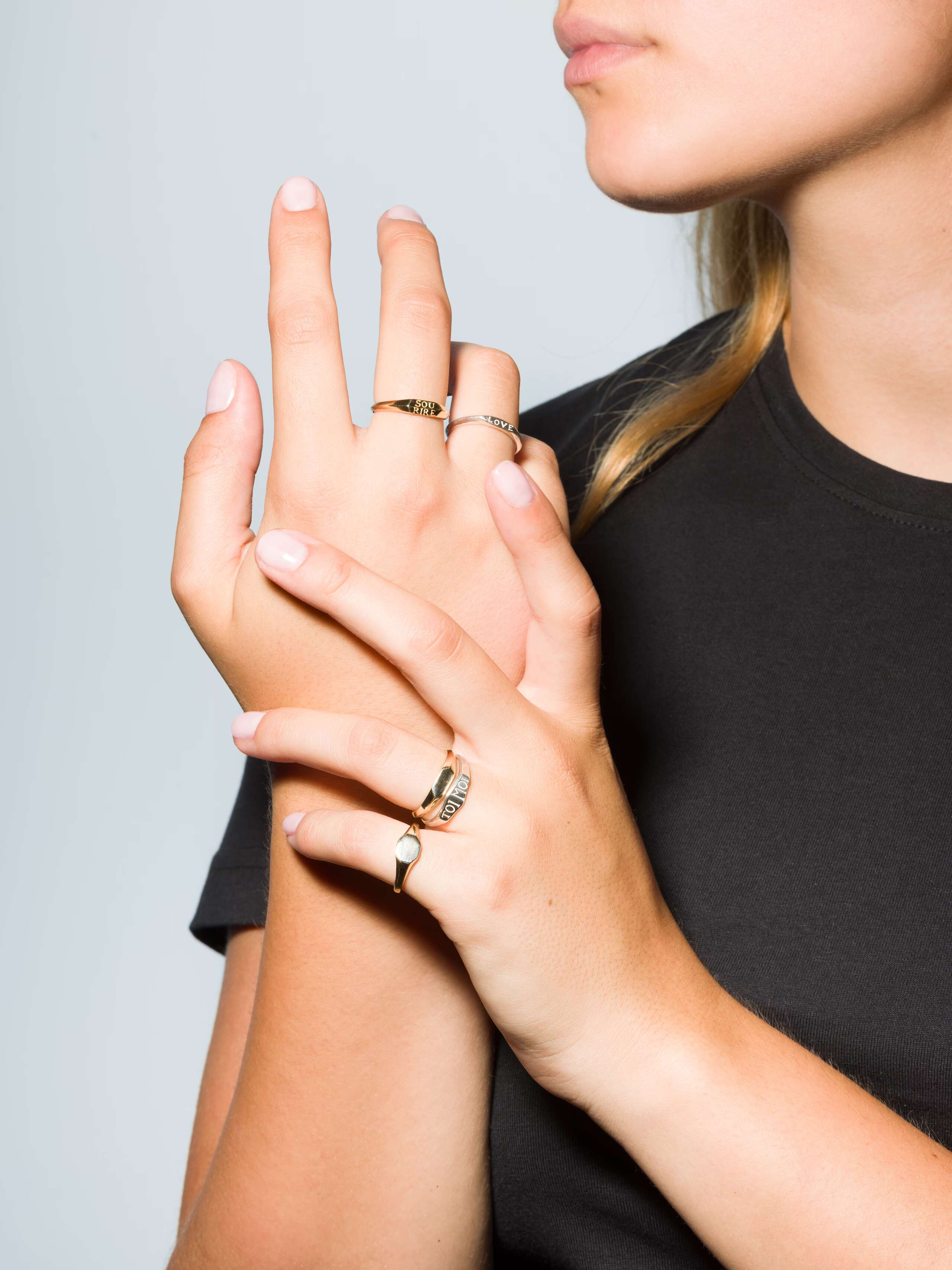 Group of Small 9 karat gold and silver signet ring called Ida on a set of hands
