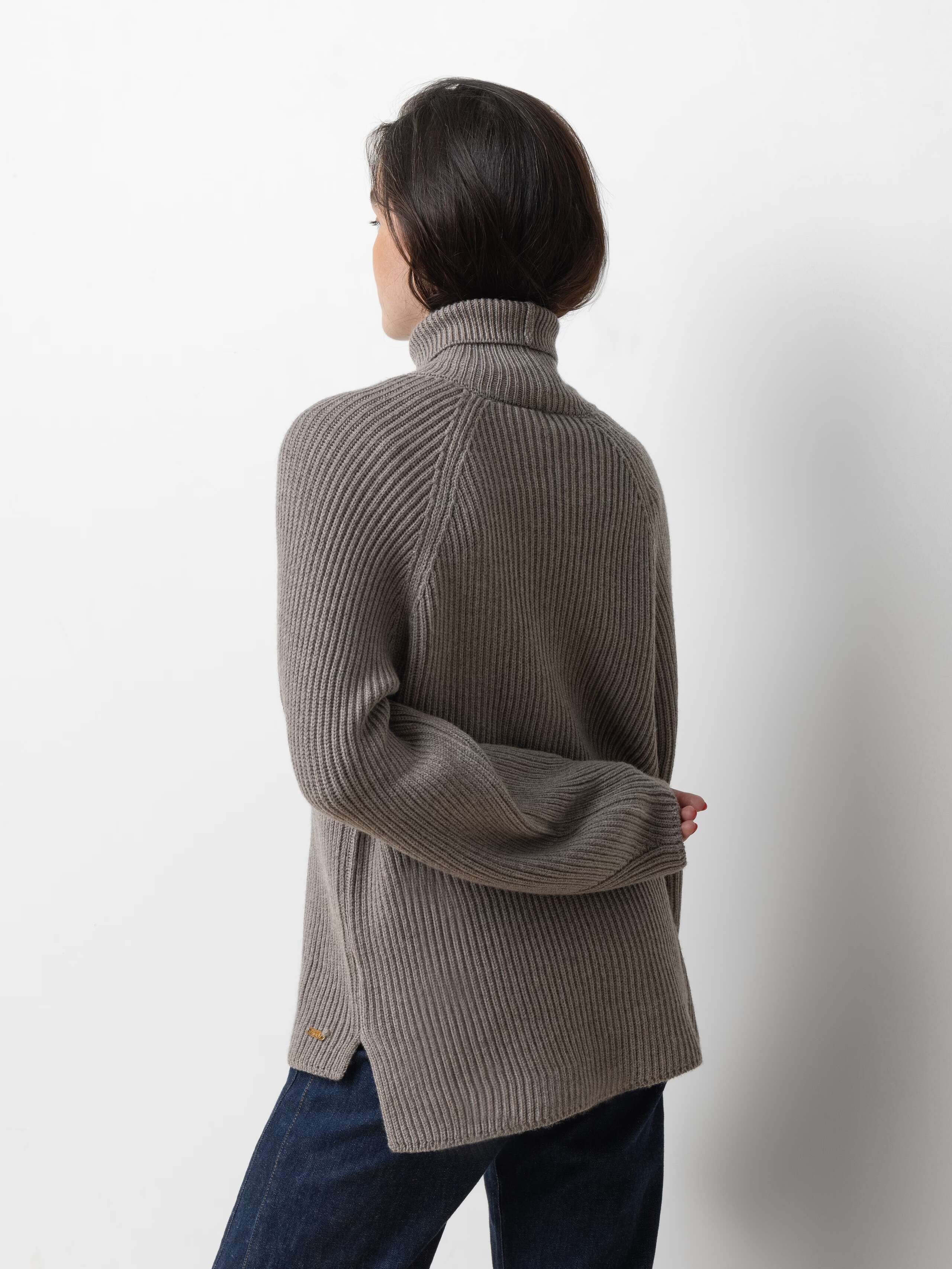 Picture of a female model wearing a beautiful brown grey merino wool sweater 