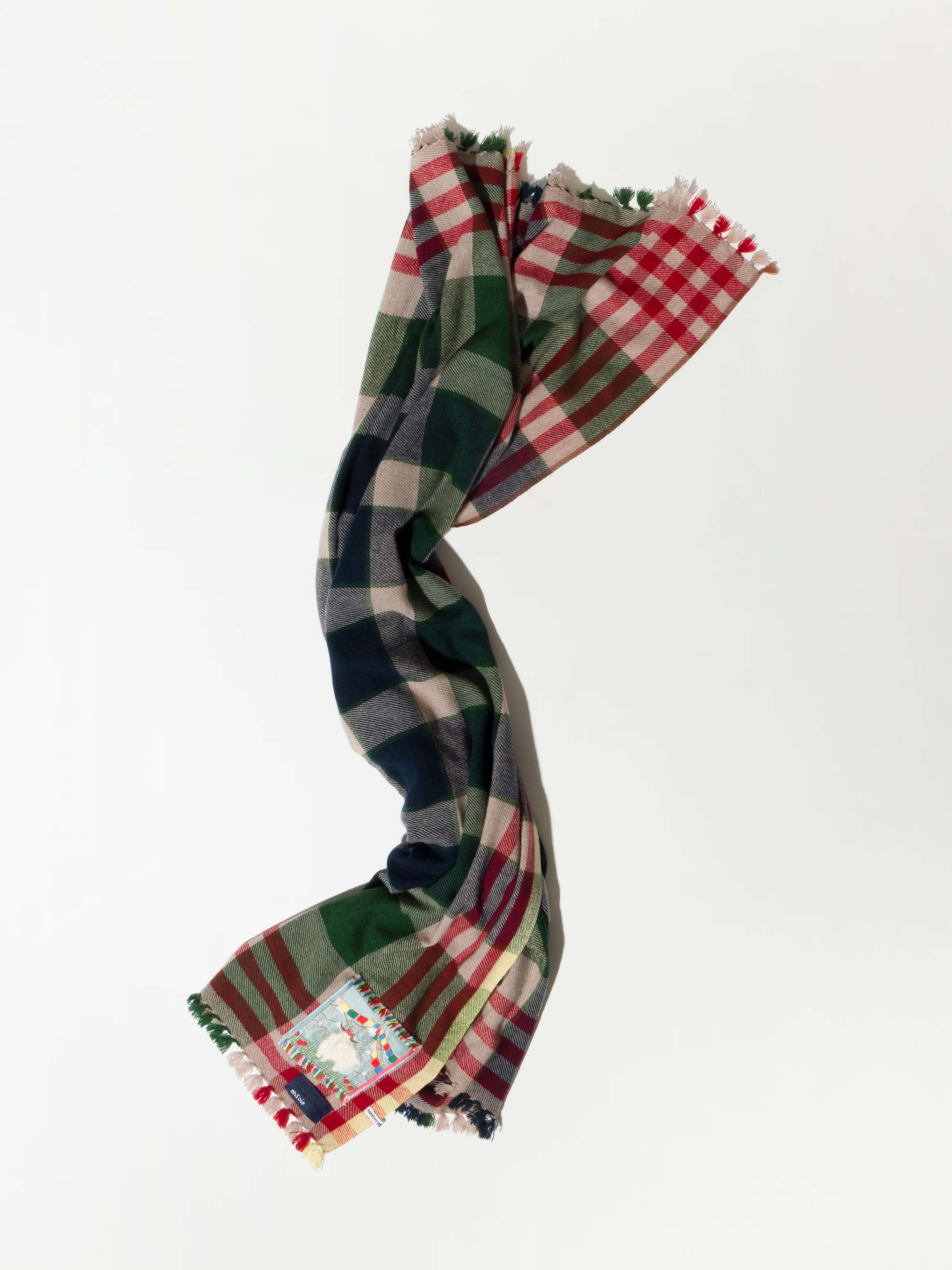 Picture of a checkered wool scarf in beautiful green, red, blue and beige shades